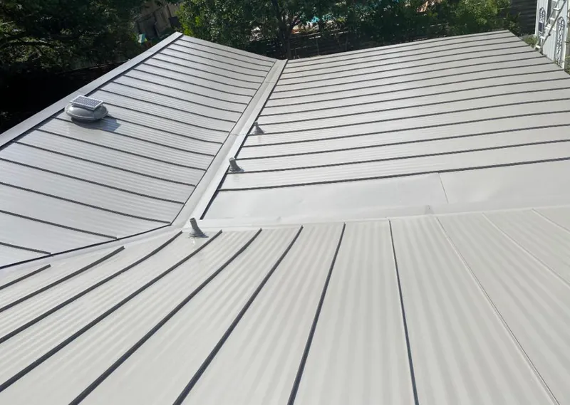 Solar attic fan installed on a metal roof for Roof Ventilation in Sheboygan Falls